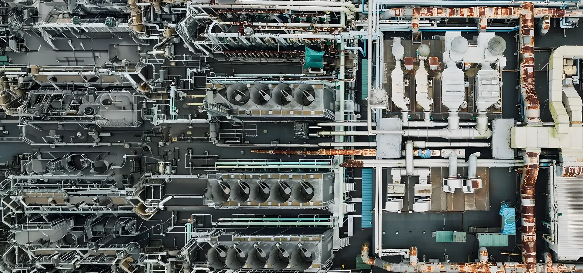 Aerial view of an industrial plant roof showing pipework, walkways and plant equipment